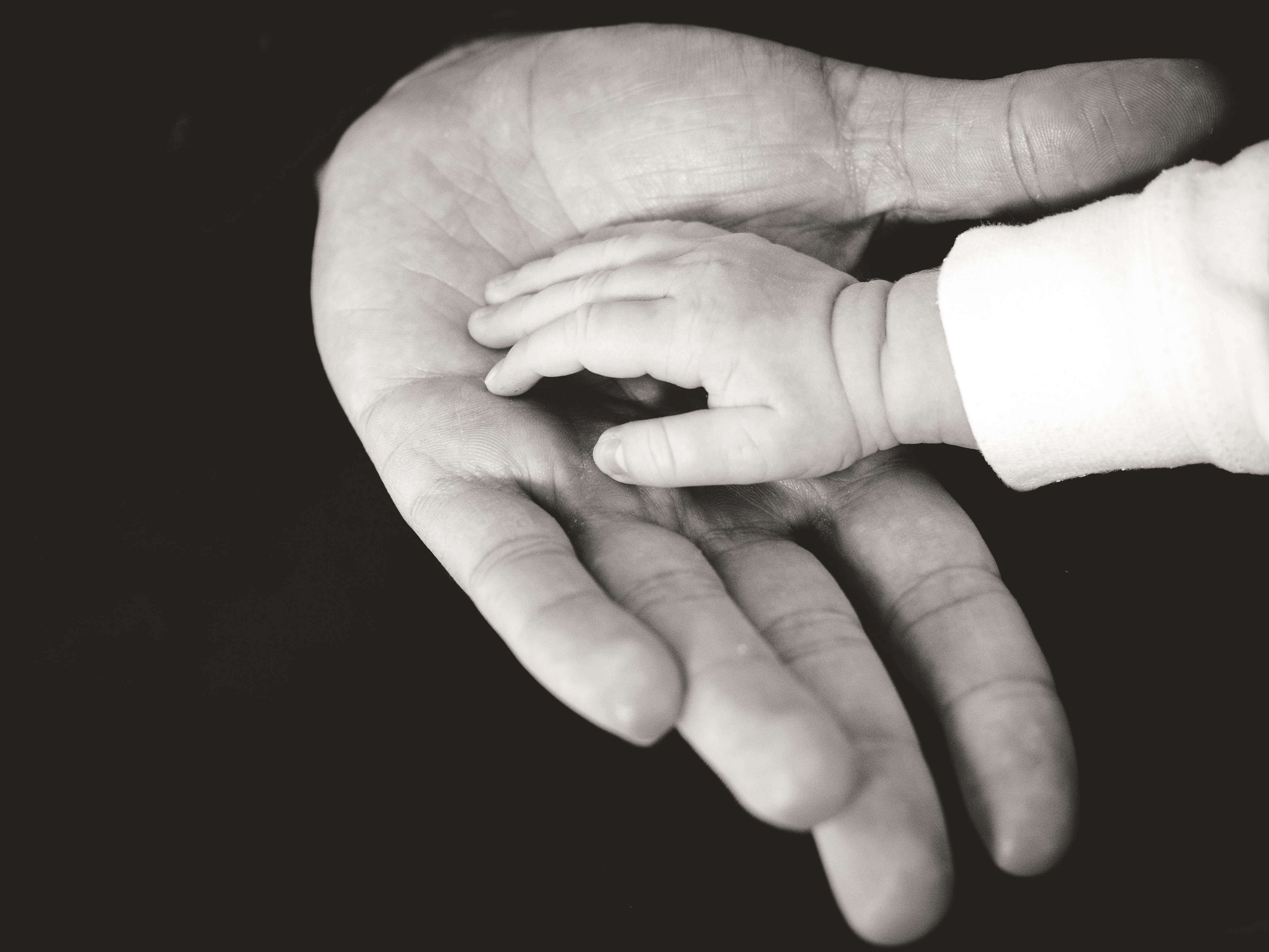 a father hand and the hand of his baby